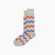Blue, red, and grey zig zag socks on grey background.