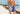 Shirtless man walking down the beach wearing half checkered half solid blue and white mesh lounge shorts.