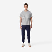 Full body front view of man wearing blue cloud pant and grey shirt.