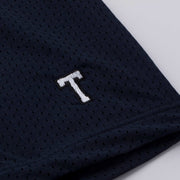 Detail texture shot of navy nylon outer mesh with T embroidery.