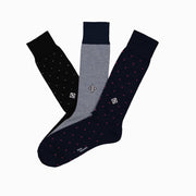 Monogram set of socks including pin dot black sparkle, birdseye blue, and pin dot navy blue pink.