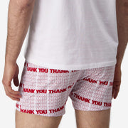 Close up back view of man wearing red and white thank you printed slim fit boxer and white t-shirt.