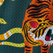 Close up detail shot of green lounge shorts with tiger and snake print.