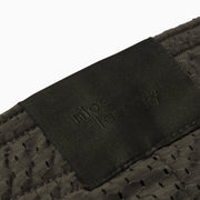 Close up detail shot of label found on olive mesh short