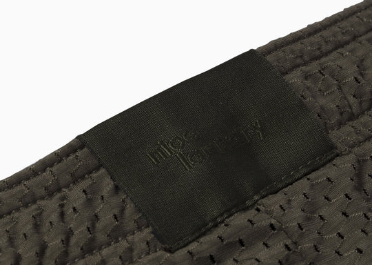 Close up detail shot of label found on olive mesh short