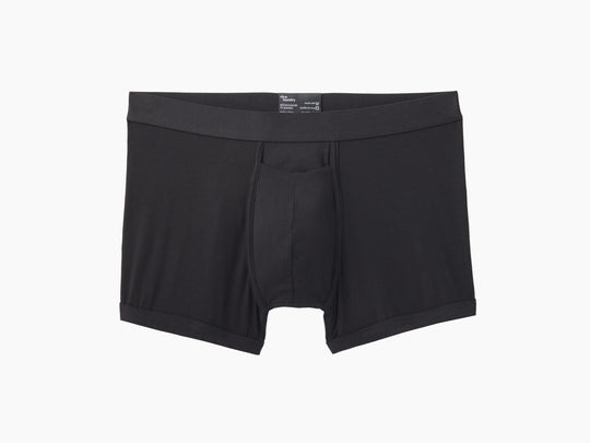 Black boxer brief layflat on grey background.
