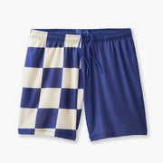 Half checkered half solid blue and white mesh lounge shorts sitting flat on grey background.