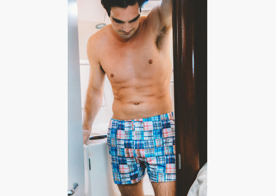 Shirtless man  in boat bathroom wearing Blue Madras Slim Fit Boxers