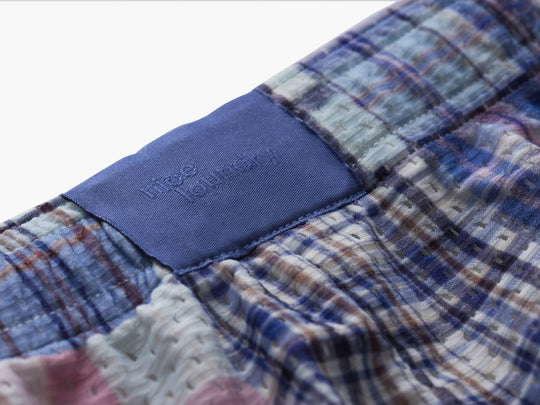 Close up detail shot of the back label found on Blue Madras Pocket Lounge Short. 