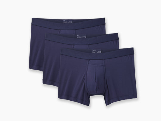 3 pairs of Navy boxer briefs on grey background.