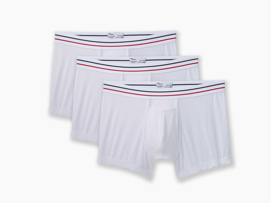 3 pairs of All American White boxer briefs on grey background.