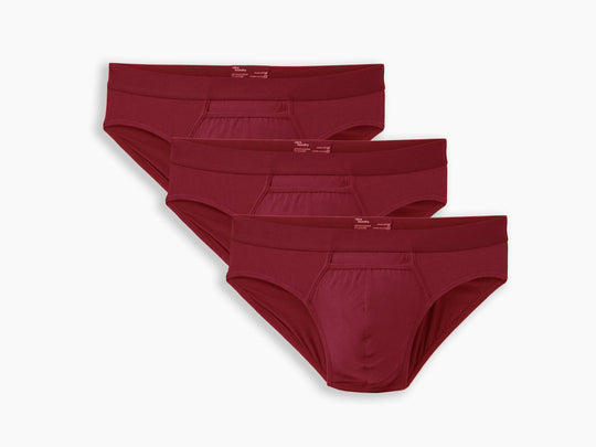 Three pairs of burgundy briefs on a white background