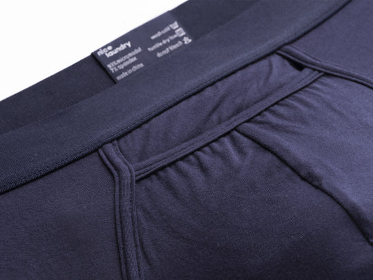 Close up detail shot of navy blue horizontal pouch found on brief.