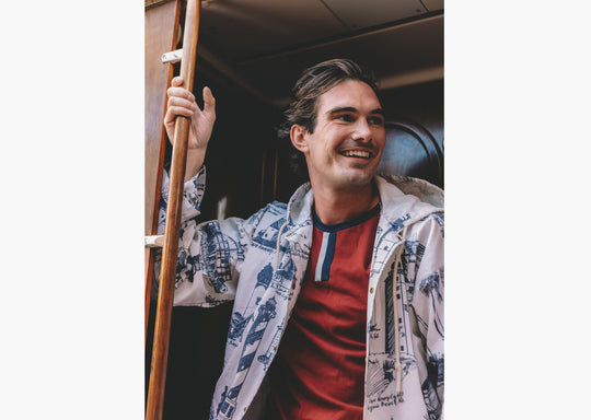 Close up of man on boat wearing burgundy vintage ringer t shirt