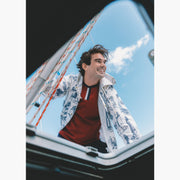 Shot of man standing on boat wearing burgundy vintage ringer t shirt