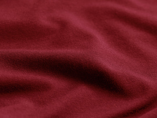 Close up detail shot of burgundy micromodal material