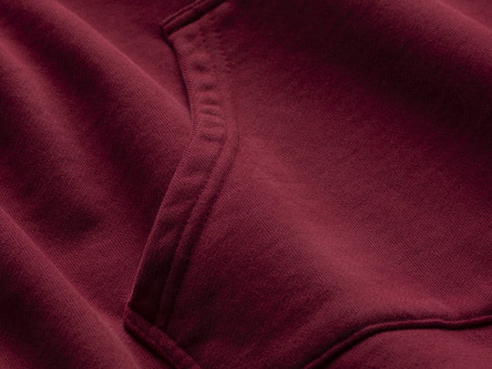 Close-up of maroon fabric with a focus on texture and color.