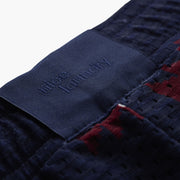 Close up detail shot of back label found on navy blue Cabin Club lounge shorts 