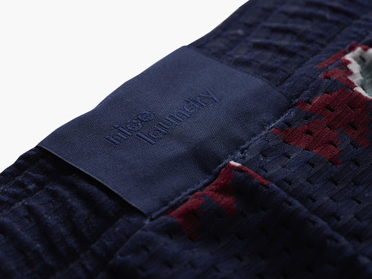 Close up detail shot of back label found on navy blue Cabin Club lounge shorts 