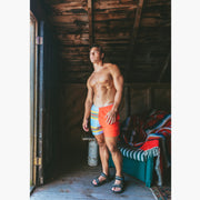 Man in boathouse wearing Canoe Stripe lounge shorts.