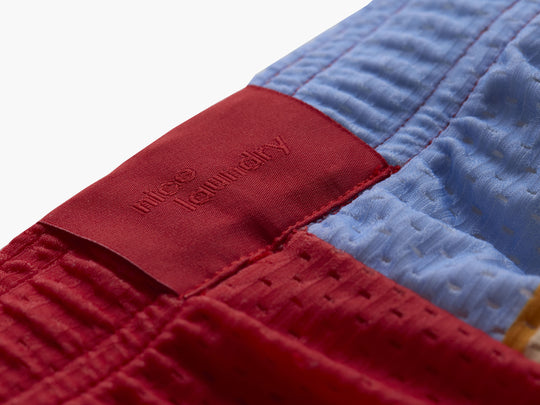 Close up detail shot of back label found on Canoe Stripe lounge short. 