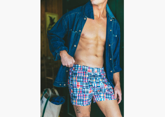 Close up of man wearing denim jacket and classic madras slim fit boxers 