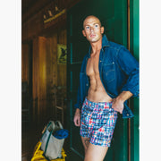 Man standing in doorway wearing denim jacket and classic madras slim fit boxers 