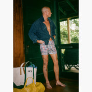 Man standing in doorway wearing denim jacket and classic madras slim fit boxers 
