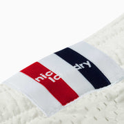 Close up detail shot of cream lounge short red/white/blue label.