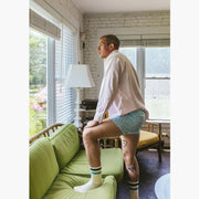Man standing inside wearing white dress shirt and Light Blue Doghouse slim fit boxer (orange with small icons like dog house, golf clubs, card etc)