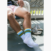 Close up shot of man resting in white chair wearing fieldhouse crew stripe socks and pink slim fit boxers.