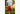 Close up back shot of man walking through forest wearing white t shirt and red/yellow colored mesh shorts.