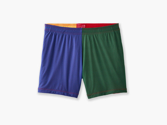 Close up shot of multi colored mesh "fun short" on a light grey background. Front colors are blue and green.