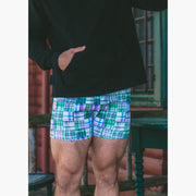 Man standing wearing black hoodie and green madras slim fit boxer