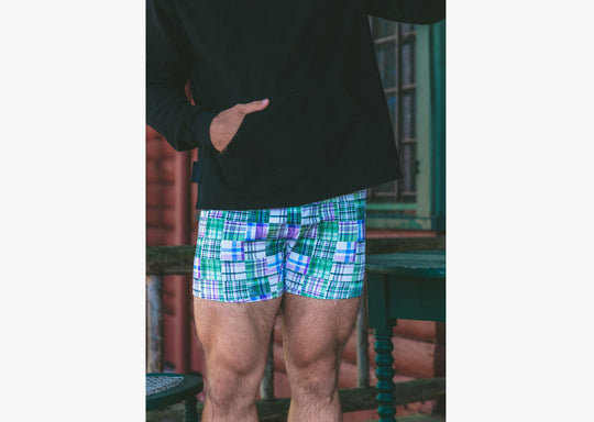 Man standing wearing black hoodie and green madras slim fit boxer