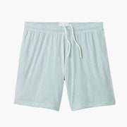 Pair of white mesh lounge short with light green interior laid flat on grey background.