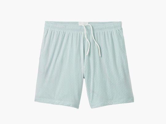 Pair of white mesh lounge short with light green interior laid flat on grey background.