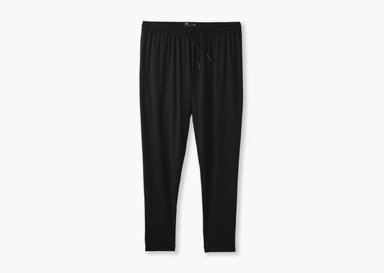 Pair of black mesh lounge pants against a light grey background.