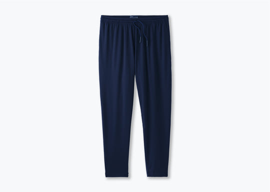 Pair of navy lounge pants sitting against light grey background. 