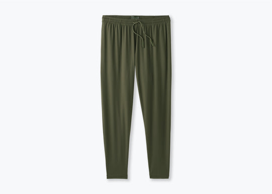 Pair of olive green lounge pants on a light grey background.
