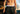 Close up of shirtless man wearing black lounge pants with red/white/blue underwear band showing.
