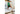 Man standing on bed wearing green jersey and white/green crew socks with letters Nila on them