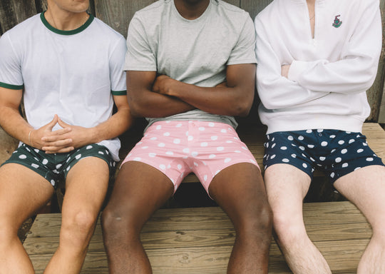 Close up shot of 3 men all wearing slim fit boxers in various colors with white dots on them.