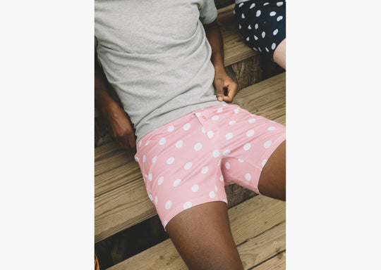 Close up shot of man wearing pink slim fit boxers with white dots.