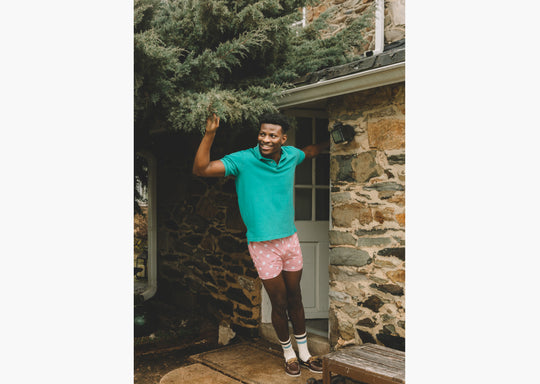 Front shot of man standing in doorway wearing green dress shirt and pink slim fit boxers with white dots