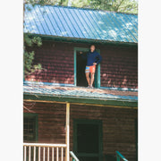 Man standing on roof wearing navy hoodie