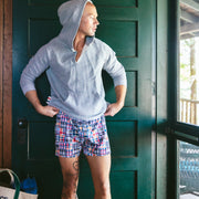 Man in heather grey hoodie by the door.