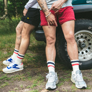 Two men leaning on a jeep in lounge shorts with tech varsity socks.