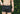 Shirtless man standing in front of bush wearing black slim fit boxer.