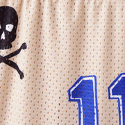 Close up detail shot of mesh material that has black skull and blue number 11.